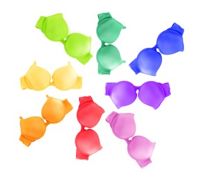 Image of Bras of different colors isolated on white, collage. Top view
