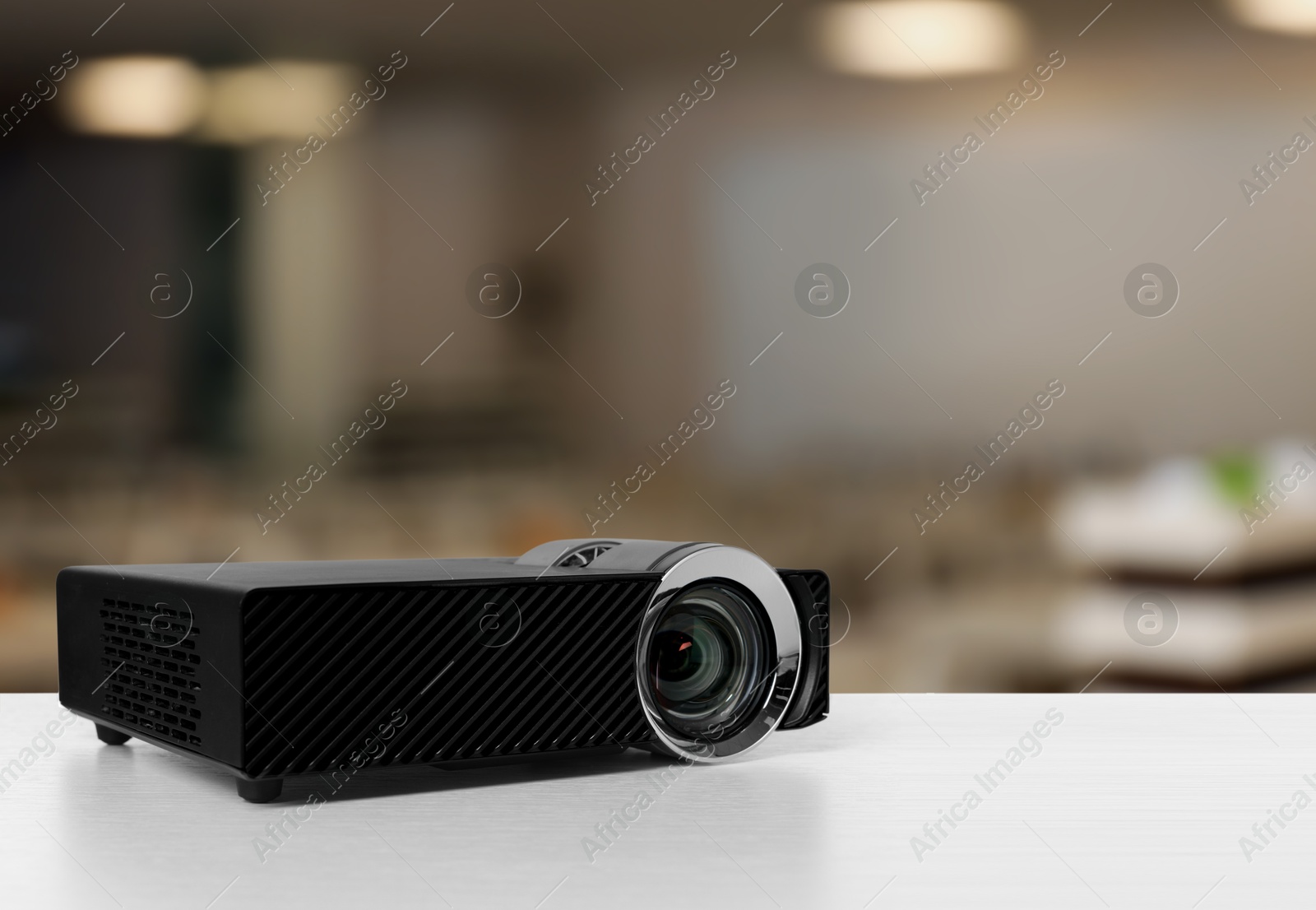 Modern video projector on white table in conference room Image of Modern video projector on white table in conference room
