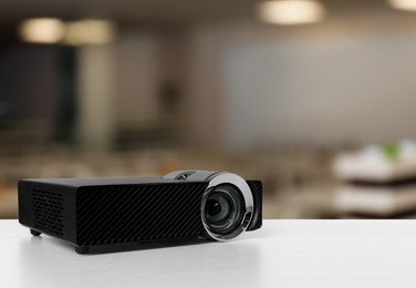 Image of Modern video projector on white table in conference room