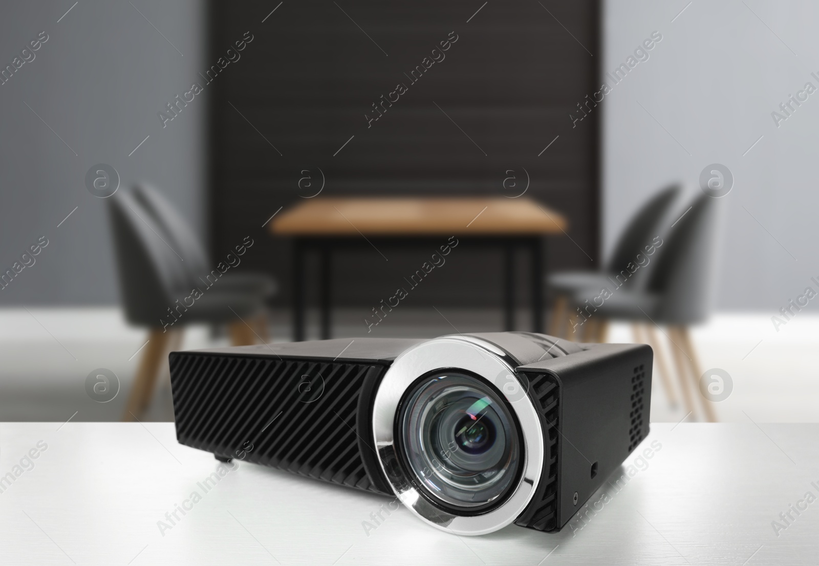 Modern video projector on white table in conference room Image of Modern video projector on white table in conference room