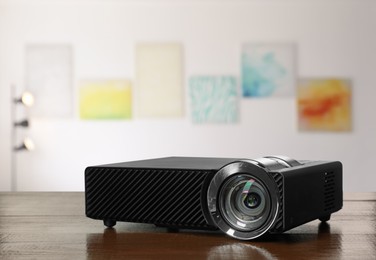 Image of Modern video projector on wooden table in art gallery