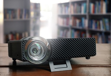 Image of Modern video projector on wooden table in library