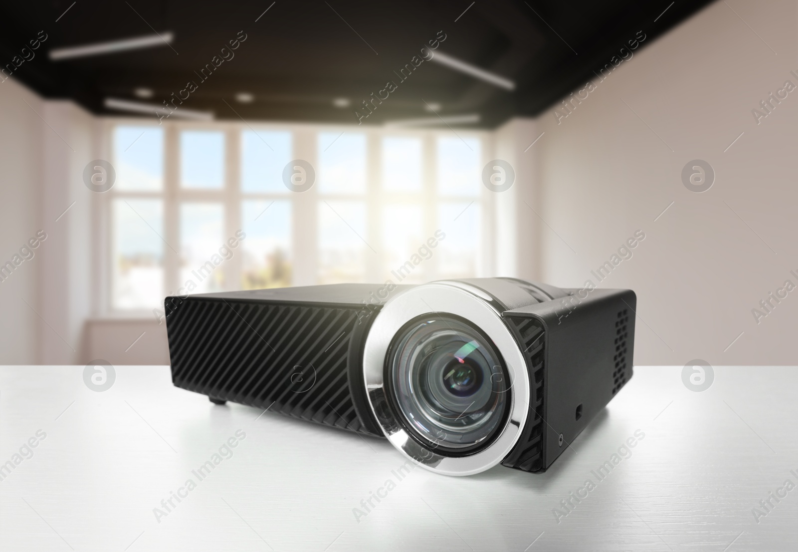Modern video projector on white table in room Image of Modern video projector on white table in room