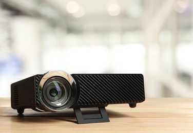 Image of Modern video projector on wooden table in office