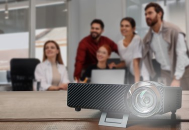 Image of Group of people watching presentation in conference room, focus on modern video projector