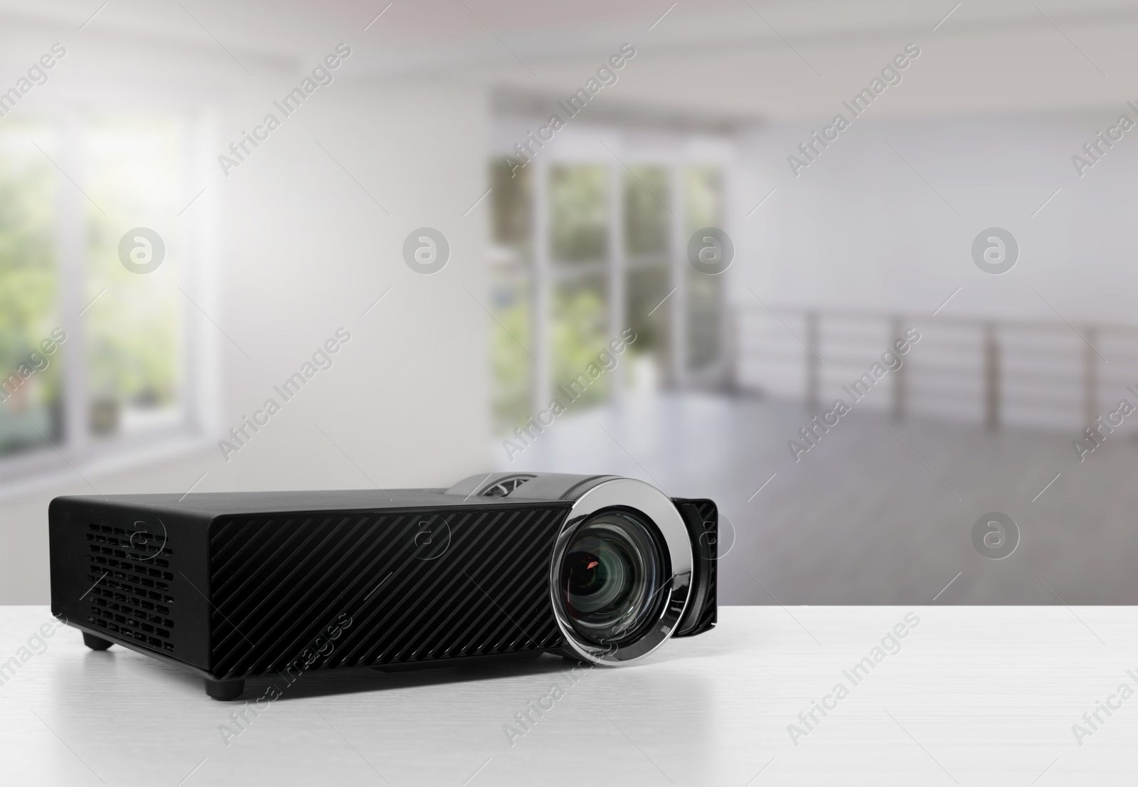Modern video projector on white table in room Image of Modern video projector on white table in room
