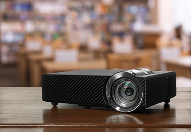 Image of Modern video projector on white table in public library