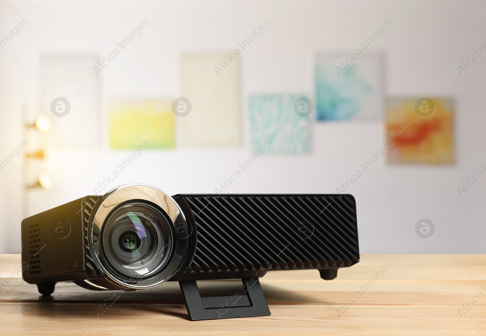 Modern video projector on wooden table in art gallery Image of Modern video projector on wooden table in art gallery