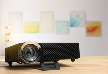 Image of Modern video projector on wooden table in art gallery