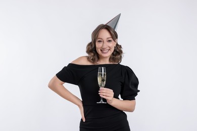Photo of Birthday celebration. Woman with glass of sparkling wine on white background
