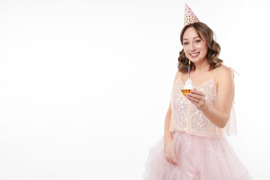 Photo of Birthday celebration. Woman with cupcake on white background. Space for text