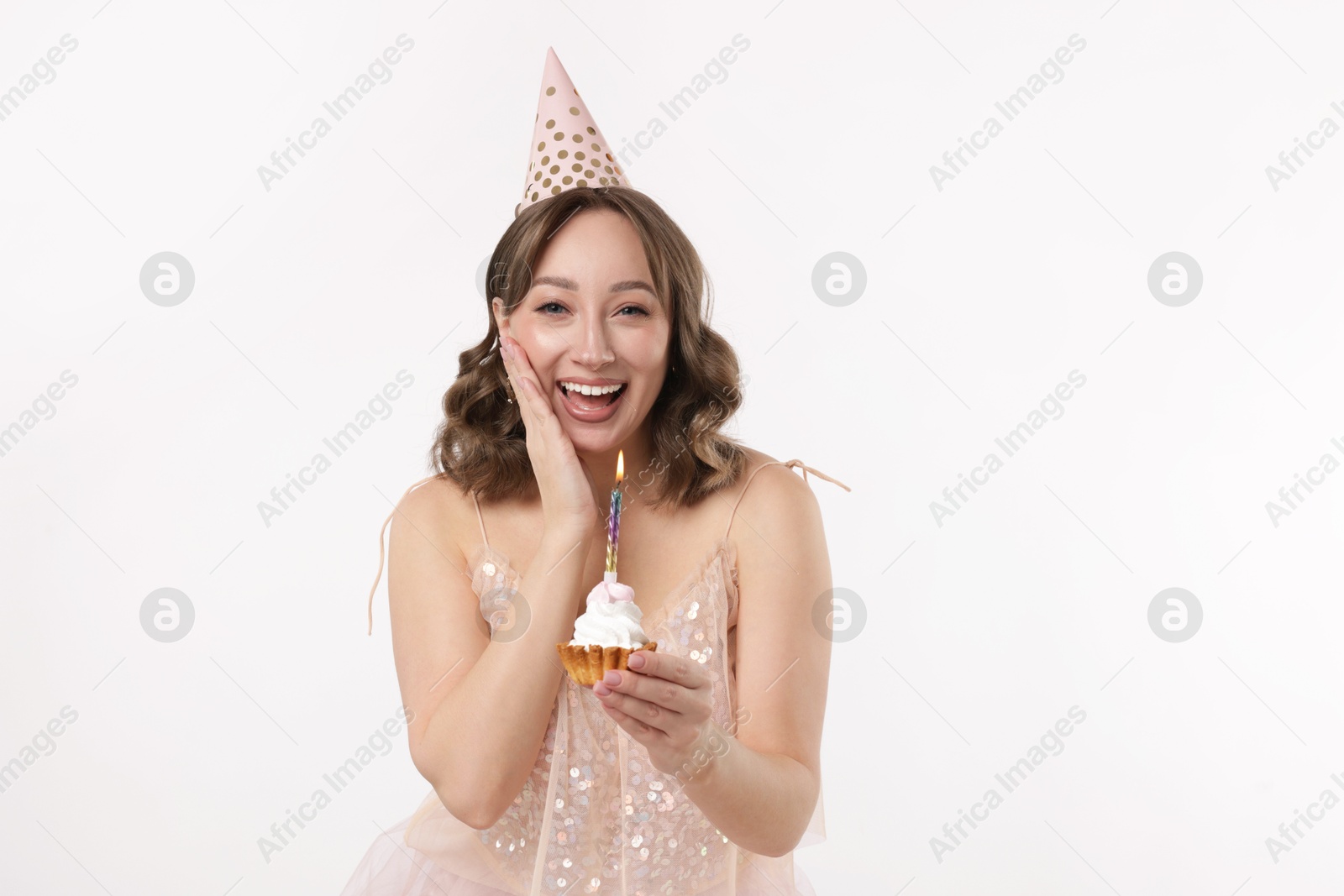 Birthday celebration. Woman with cupcake on white background Photo of Birthday celebration. Woman with cupcake on white background