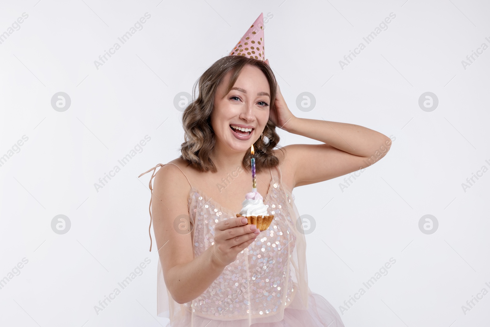 Birthday celebration. Woman with cupcake on white background Photo of Birthday celebration. Woman with cupcake on white background