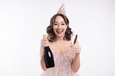 Photo of Birthday celebration. Woman with sparkling wine on white background