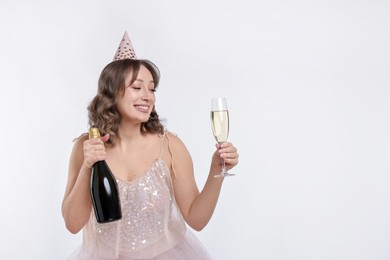 Photo of Birthday celebration. Woman with sparkling wine on white background. Space for text