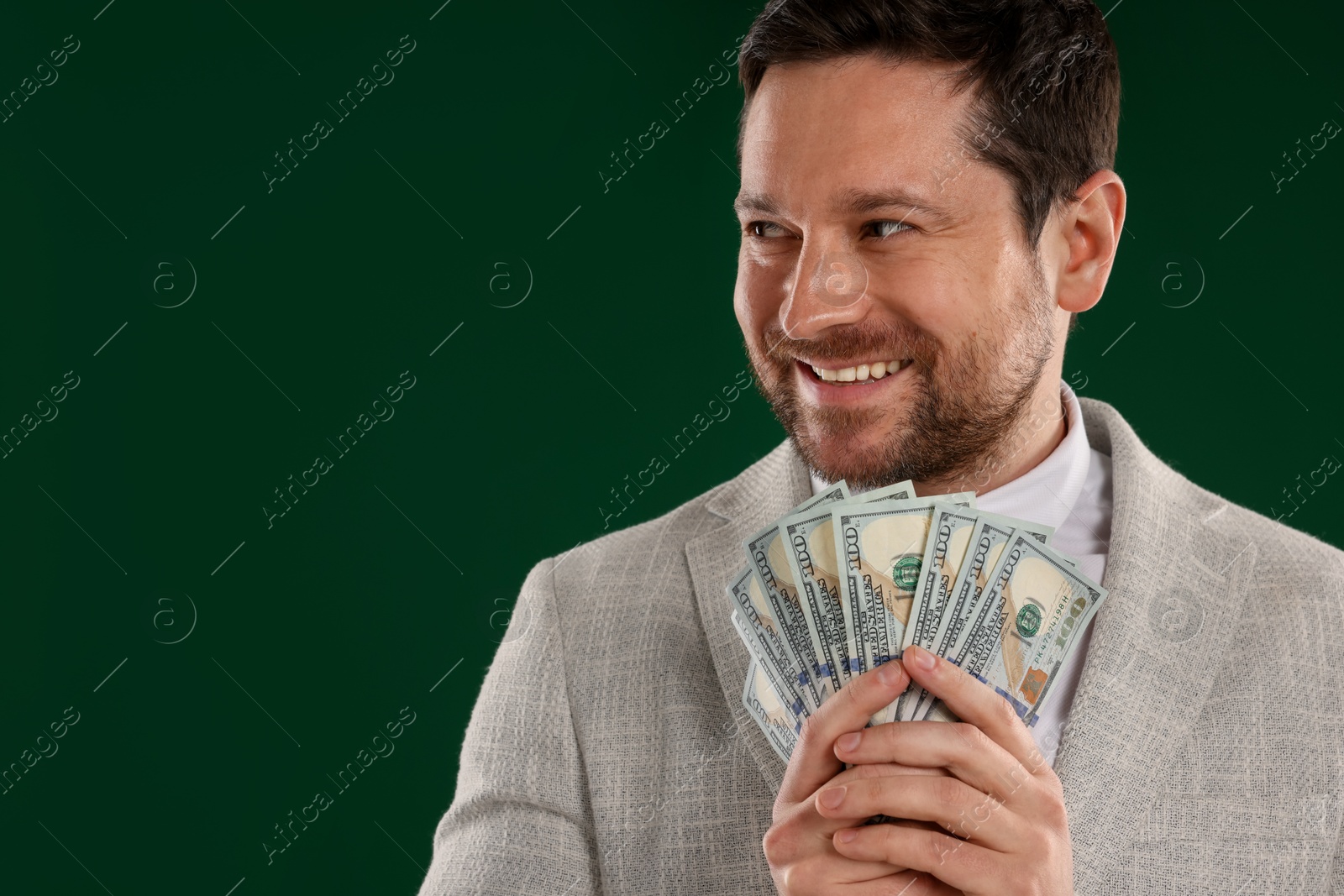 Happy greedy banker with dollar banknotes on green background. Space for text Photo of Happy greedy banker with dollar banknotes on green background. Space for text