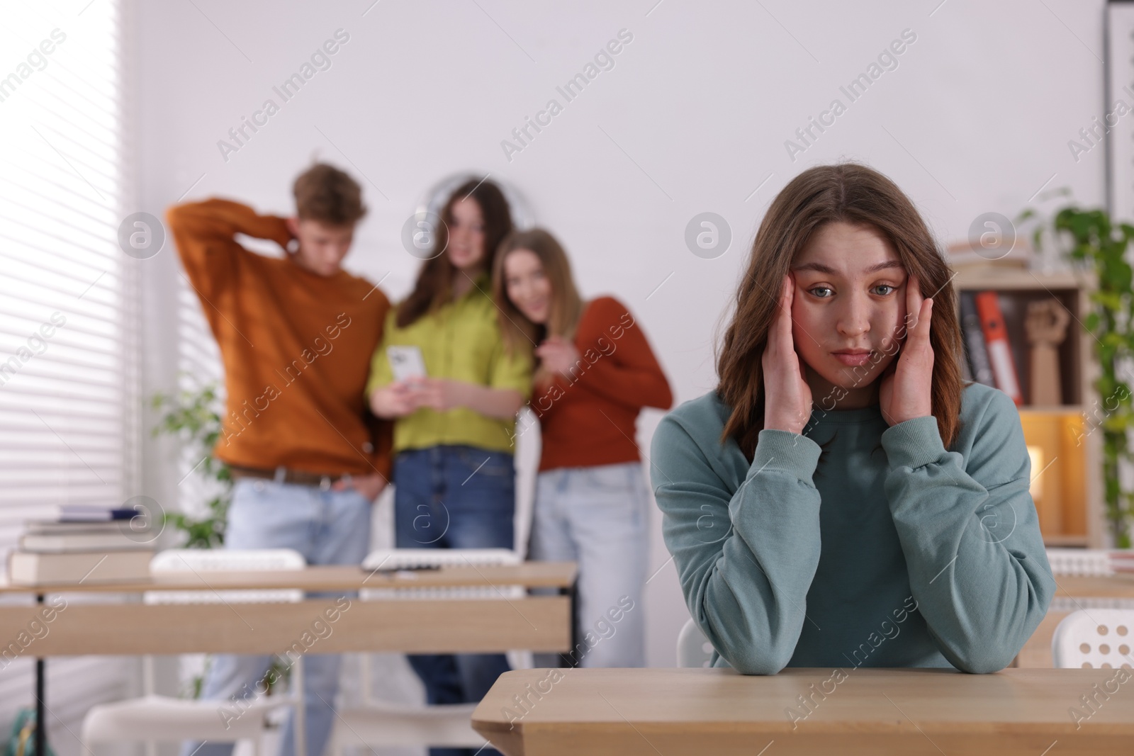 Photo of Teenage girl suffering from bullying at school, selective focus