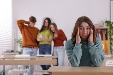 Photo of Teenage girl suffering from bullying at school, selective focus