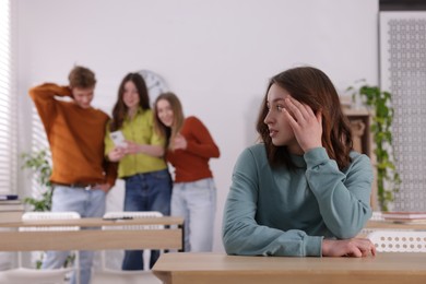 Photo of Teenage girl suffering from bullying at school, selective focus