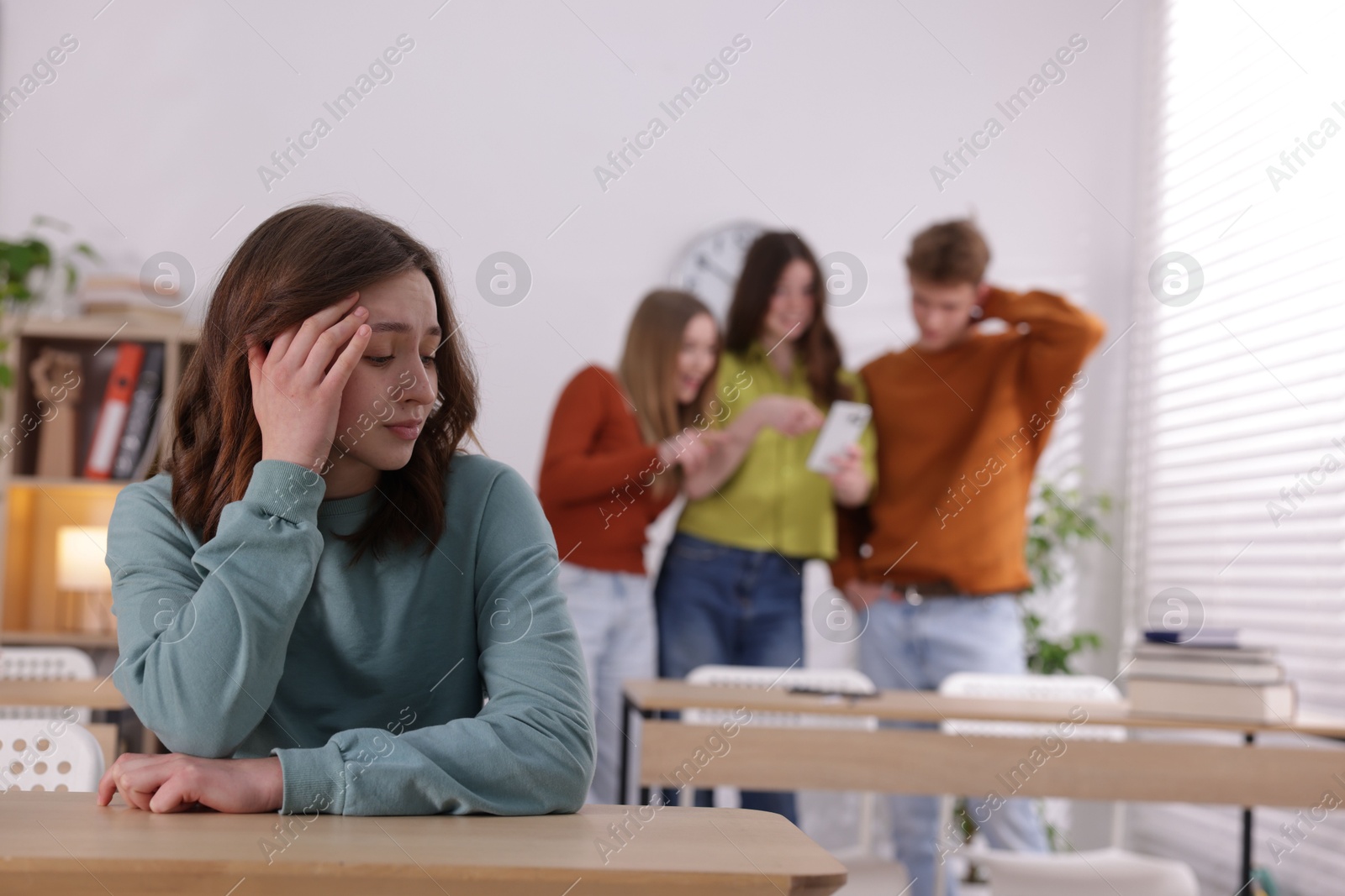 Photo of Teenage girl suffering from bullying at school, selective focus