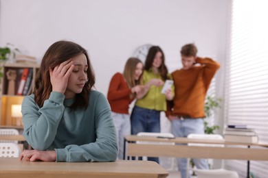 Photo of Teenage girl suffering from bullying at school, selective focus