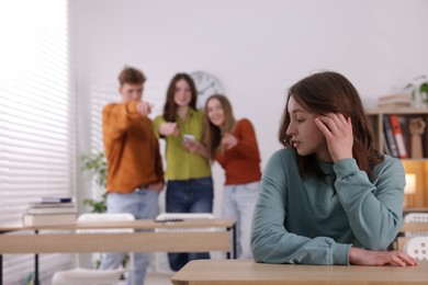 Photo of Teenage girl suffering from bullying at school, selective focus