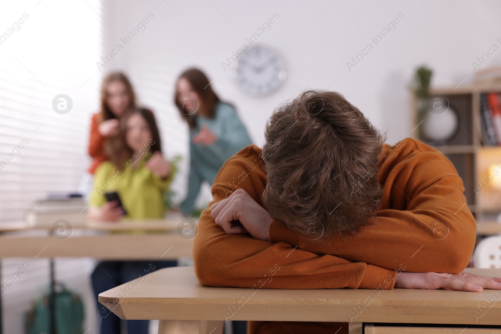 Teenage boy suffering from bullying at school, selective focus Photo of Teenage boy suffering from bullying at school, selective focus