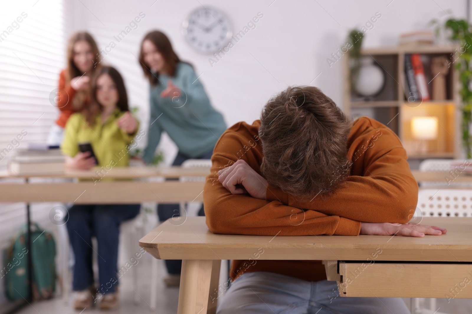 Teenage boy suffering from bullying at school, selective focus Photo of Teenage boy suffering from bullying at school, selective focus