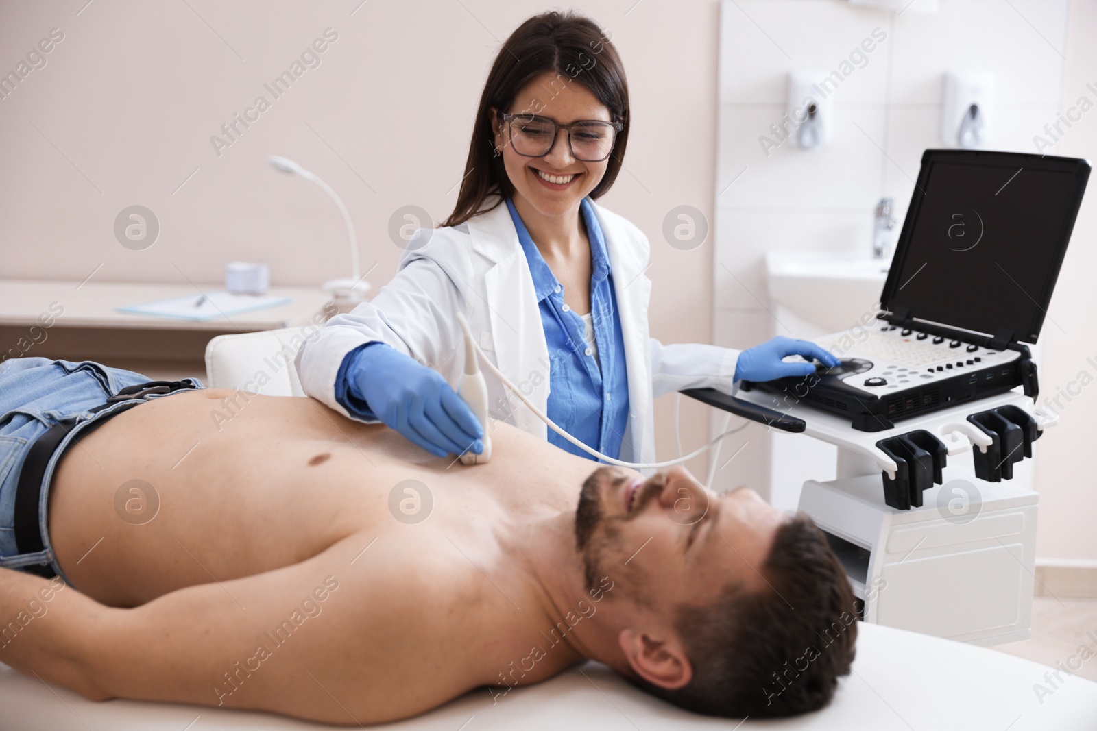 Sonographer conducting ultrasound examination of man's heart in clinic Photo of Sonographer conducting ultrasound examination of man's heart in clinic