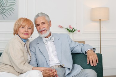 Photo of Lovely senior couple together on sofa at home