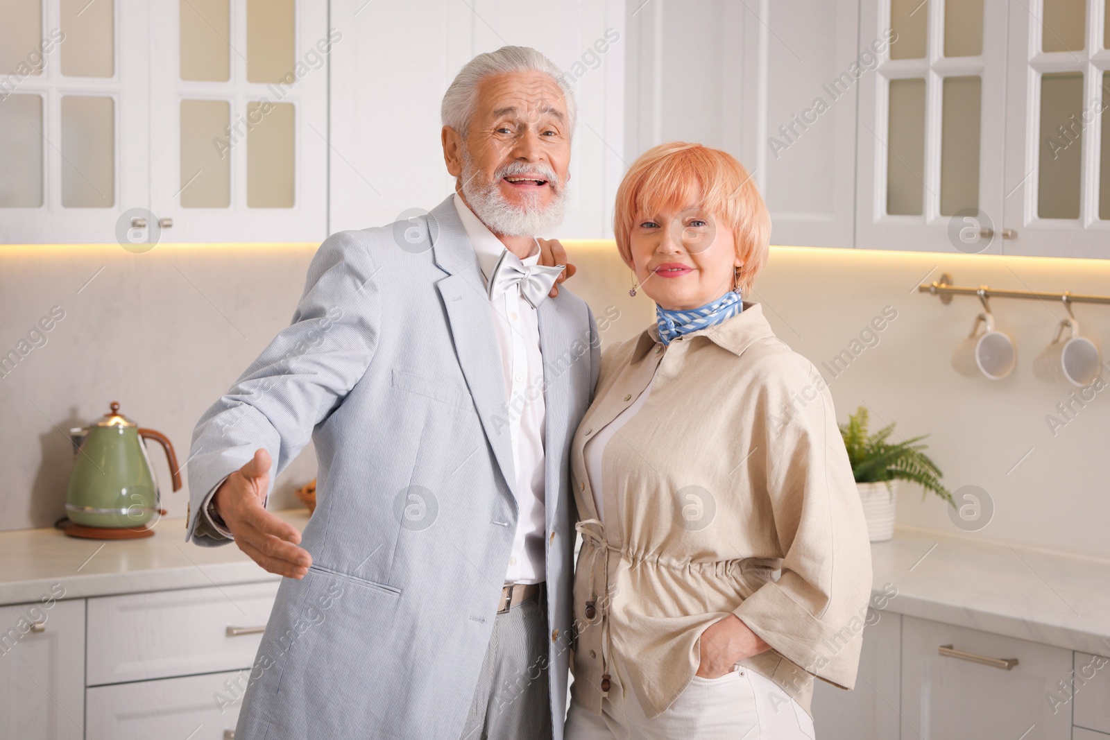 Lovely senior couple together in kitchen at home Photo of Lovely senior couple together in kitchen at home