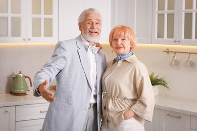 Photo of Lovely senior couple together in kitchen at home