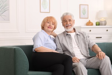 Photo of Lovely senior couple together on sofa at home