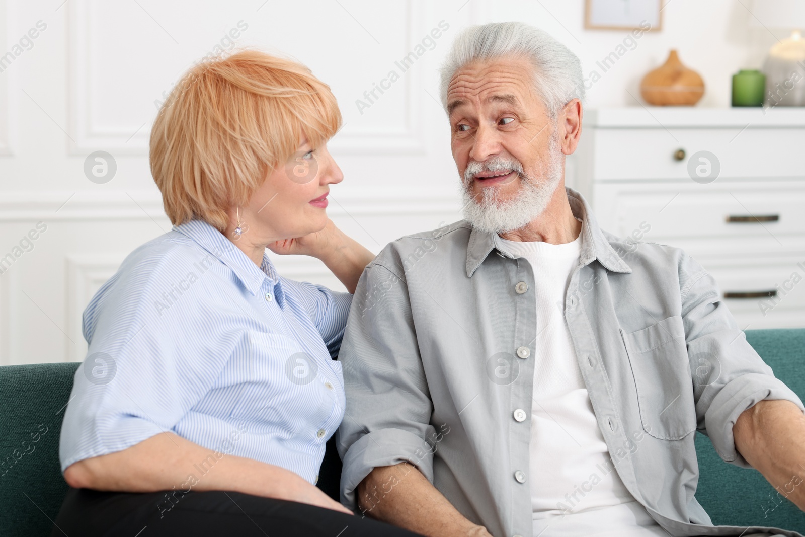Lovely senior couple together on sofa at home Photo of Lovely senior couple together on sofa at home