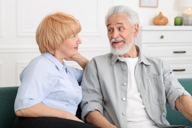 Photo of Lovely senior couple together on sofa at home