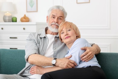 Photo of Lovely senior couple together on sofa at home