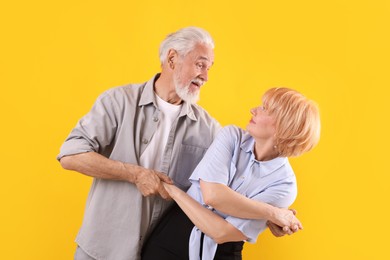 Photo of Lovely senior couple together on yellow background