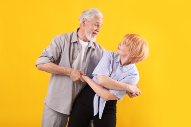 Photo of Lovely senior couple together on yellow background