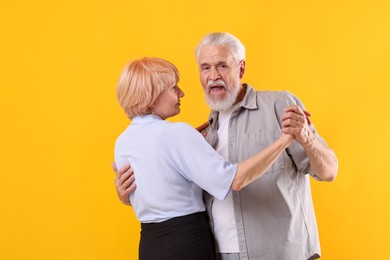 Photo of Lovely senior couple together on yellow background