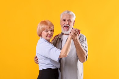Photo of Lovely senior couple together on yellow background