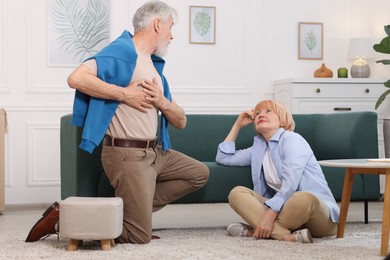 Photo of Lovely senior couple together on floor at home