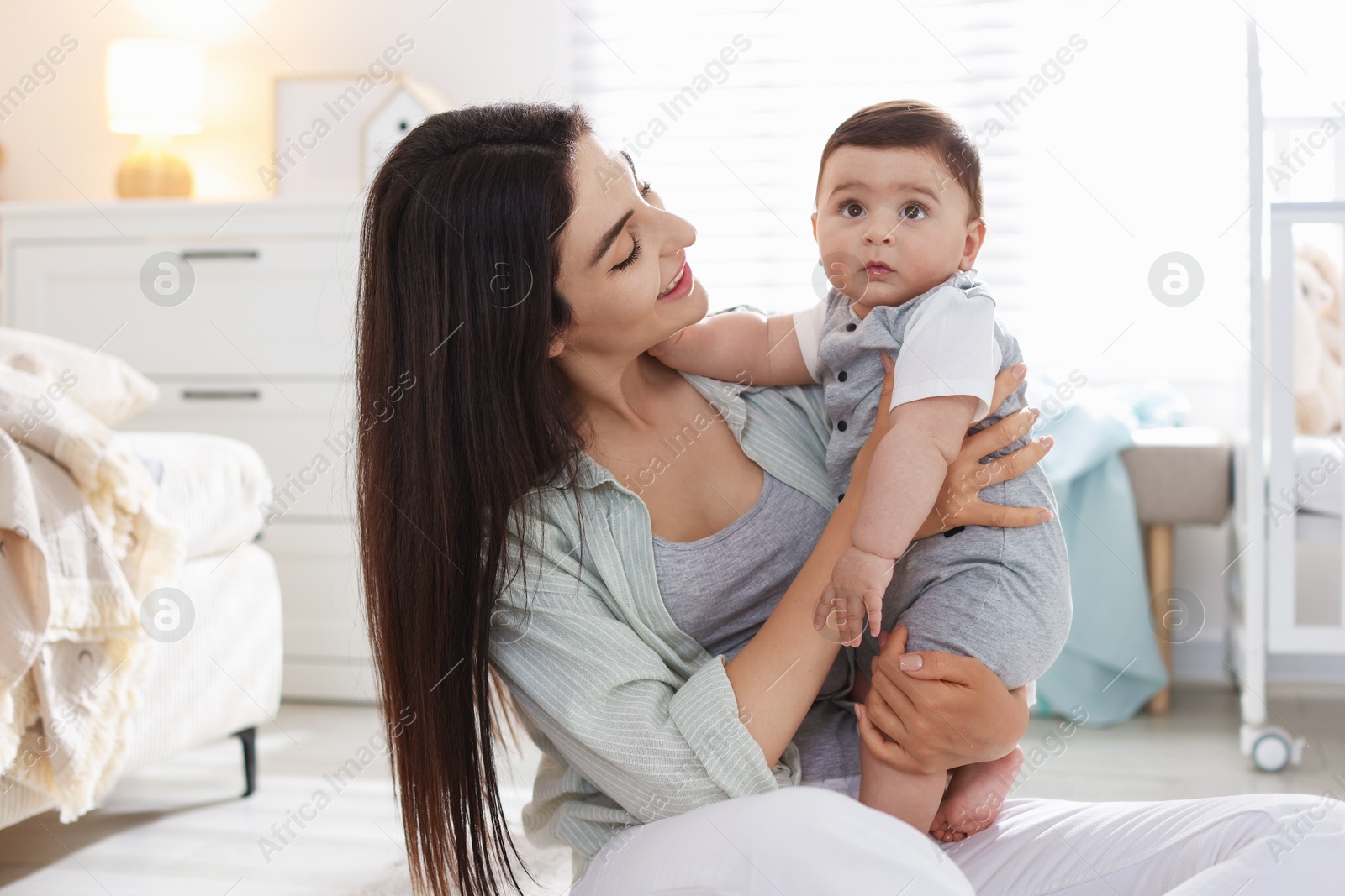 Mother with her cute baby at home Photo of Mother with her cute baby at home