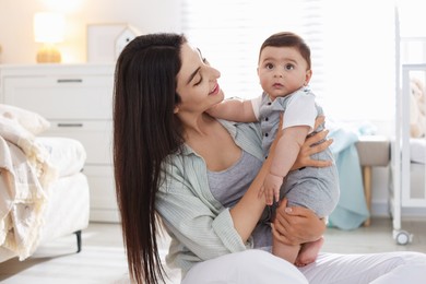 Photo of Mother with her cute baby at home
