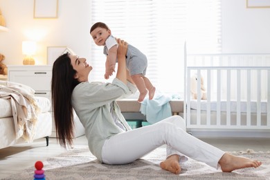 Photo of Mother with her cute baby at home. Space for text