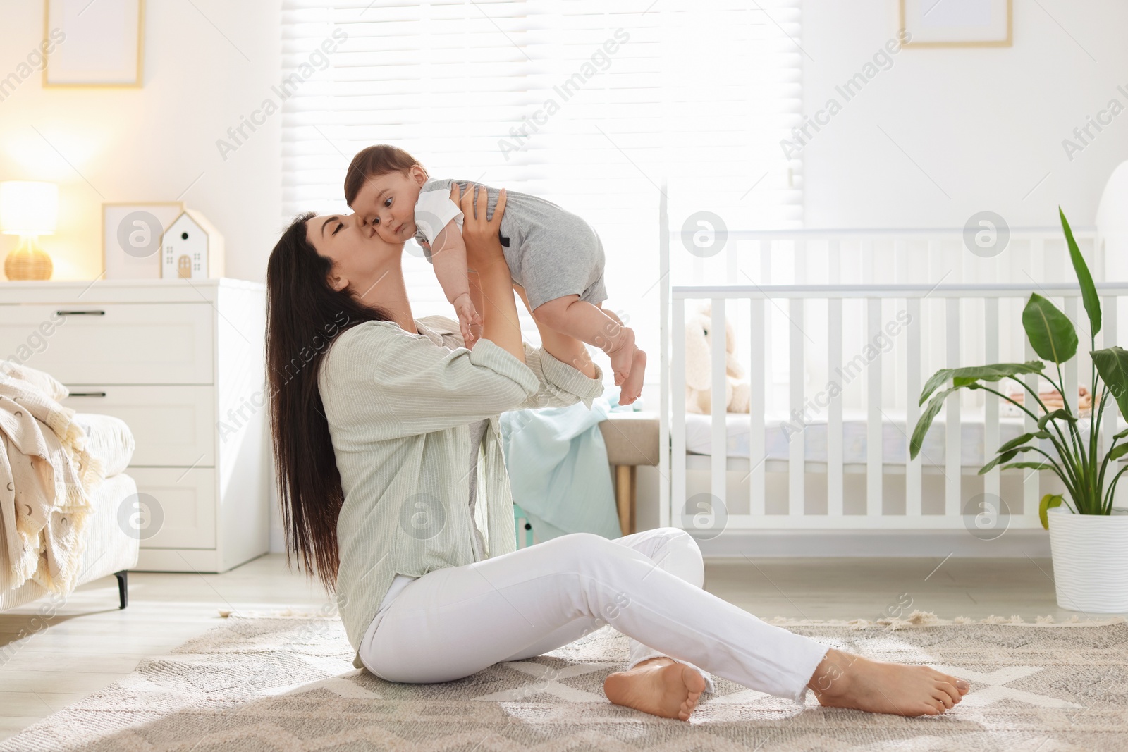 Mother with her cute baby at home. Space for text Photo of Mother with her cute baby at home. Space for text