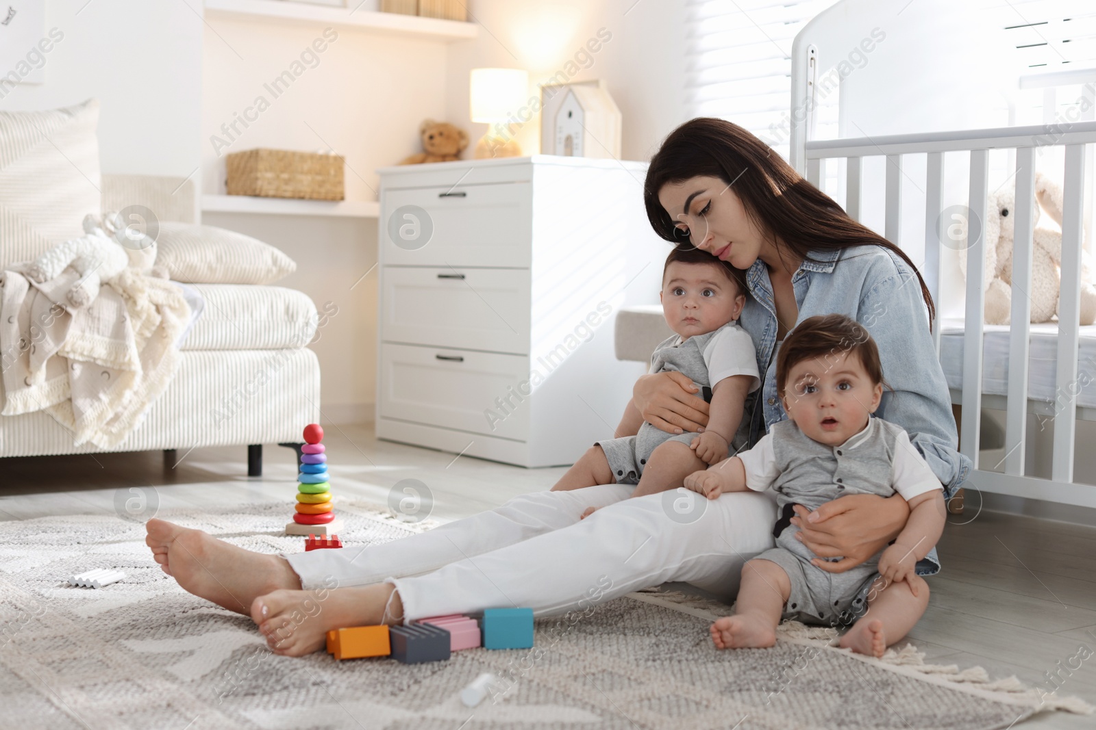 Woman suffering from postpartum depression with her little children at home. Space for text Photo of Woman suffering from postpartum depression with her little children at home. Space for text