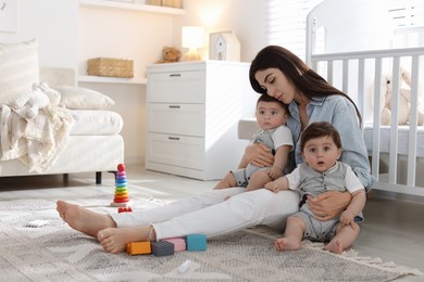 Photo of Woman suffering from postpartum depression with her little children at home. Space for text