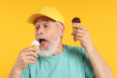Photo of Elderly man in stylish outfit eating ice cream on orange background