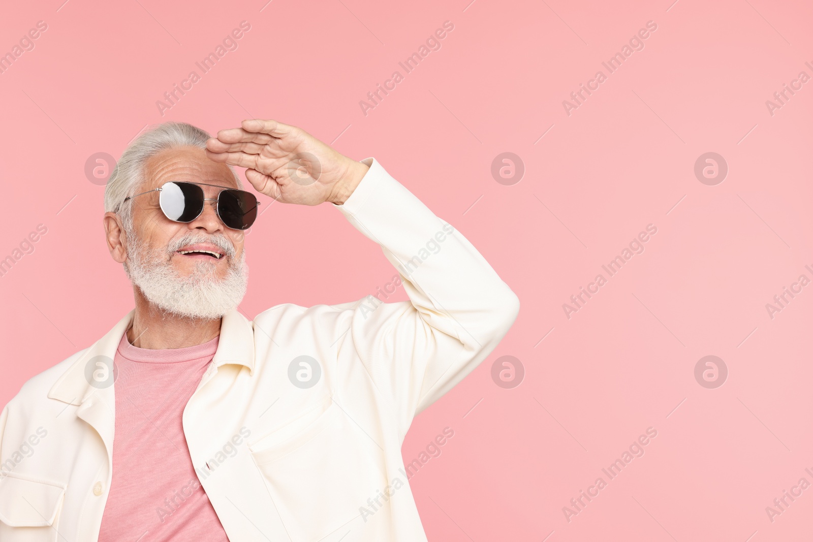 Elderly man in stylish outfit on pink background, space for text Photo of Elderly man in stylish outfit on pink background, space for text