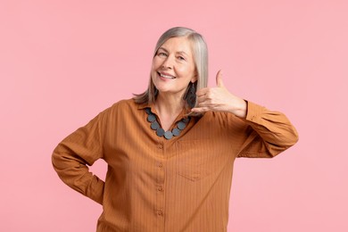 Photo of Senior woman in stylish outfit on pink background